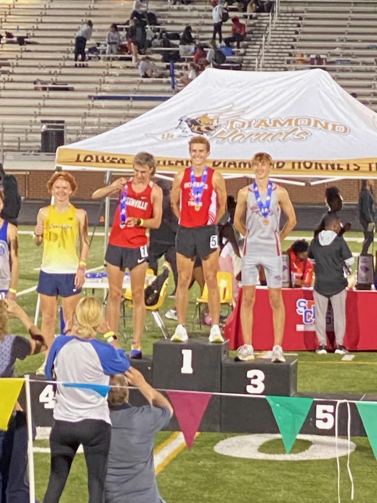 Jake Wadas standing #1 on the podium at the 2023 State Track Meet after he won the 3200m race.